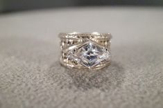 I am offering you this vintage sterling silver (stamped ) wedding band stacker design ring. It features a bold marquise shaped prong  set genuine white topaz stone, set in an east to west fashion.  Truly a most spectacular detailed Art Deco  style ring. It features a detailed etched inter woven design setting. It is currently a size 6.5,  though I am sure this could easily be sized up or down. It measures app. 3/4 inch, by  app.   1/2  inch and it weighs app. 7  grams. This is a must have to add Silver Marquise Cut Jewelry For Marriage, Silver Stackable Marquise Rings, Vintage Silver Marquise-shaped Jewelry, Vintage Marquise Silver Jewelry, Vintage Silver Marquise Jewelry, Vintage Diamond-shaped Anniversary Jewelry, Unique Silver Marquise Cut Rings, Unique Silver Marquise Jewelry, Silver Solitaire Marquise Wedding Ring