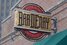 the restaurant sign for barbequery is hanging from the side of a brick building