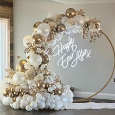 a white and gold christmas tree with balloons