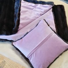 three pillows on top of each other with fur trimming around the edges and sides