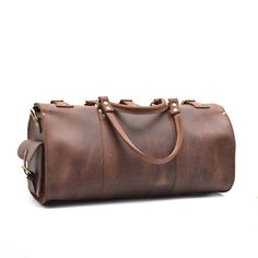 The Weekender Duffle is now available in dark brown and tobacco vintage cowhide leather. This leather has a more rustic finish than our standard veg-tan leather Weekenders. Ready to escape for a few days? Whether it's a weekend road trip or an overseas flight, the Marlondo Leather Weekender Duffle Bag helps you travel in comfort and style. It's easy to pack, easy to carry, and will only look more beautiful with time and use. Its single, spacious compartment will readily house all your travel gea Everyday Brown Bridle Leather Satchel, Leather Weekender Bag In Cognac With Smooth Grain, Cognac Leather Travel Bag With Leather Backing, Cognac Leather Duffle Bag With Soft Leather, Cognac Leather Weekender Bag With Smooth Grain, Vintage Smooth Grain Shoulder Bag For Travel, Cognac Leather Duffle Bag With Leather Backing, Cognac Leather Duffle Bag With Leather Lining, Brown Oiled Leather Satchel With Waxed Finish