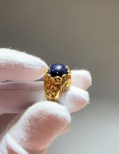 Gold Galaxy Blue Goldstone Silver Promise Ring, Sterling Silver 18K Gold Plated Handmade Filigree Engagement Women Ring, Sandstone Ring celestial boho ring, victorian ring, Edwardian ring, special gift for her, ring for girlfriend, shiny sandstone ring, tiny universe ring Material: 925 Sterling Silver 18K Gold Plated ( NICKEL FREE ) Gemstone: Blue Goldstone 10 mm. FREE, FAST AND TRACKABLE SHIPPING FOR ALL EU COUNTRIES AND USA. COMES WİTH VELVET POUCH AND LUXURY GİFT BOX. Introducing the Gold Galaxy Blue Goldstone Promise Ring, a stunning fusion of elegance and craftsmanship. This sterling silver ring, beautifully plated in 18K gold, features an enchanting Blue Goldstone that shimmers like the night sky, making it the perfect symbol of love and commitment. Handcrafted with intricate filigre Universe Ring, Goldstone Ring, Sandstone Ring, Celestial Boho, Gold Galaxy, Silver Promise Rings, Edwardian Ring, Victorian Ring, Special Gifts For Her