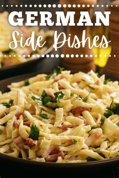 a bowl filled with pasta and ham on top of a table next to other dishes