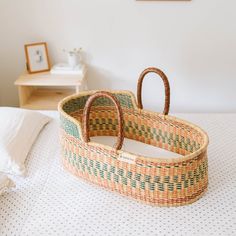 a woven basket sitting on top of a bed