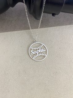 a silver necklace with the word soothe on it and a fern leaf in the center