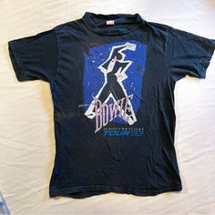 **David Bowie Serious Moonlight Tour '83 T-Shirt** Yep, It’s The Real Deal Folks! I’m Selling This For My Friend. It Belonged To Her Brother, Who Got To See David Bowie Play On The Serious Moonlight 1983 Tour In Europe (I’m Green With Envy!!). I’ve Spent The Past Several Months Trying To Find A Comp For It, And It’s Apparently A Complete Unicorn (Because Who Would Ever Get Rid Of This??). I Only Found Some Sold From The American Tour. Obviously Faded With Wear, But I Couldn’t Find Any Holes. If It Were My Size, I Would Buy It From Her In A Heartbeat. Size Tag Illegible, See Photos For Measurements. Some Lucky Bowie Fan Can Have An Authentic Piece Of Bowie History. Green With Envy, For My Friend, European Tour, Tour Shirt, Her Brother, David Bowie, In A Heartbeat, Vintage Shirts, Vintage Tops