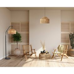 a living room filled with furniture next to a lamp and potted plant on top of a hard wood floor