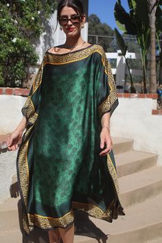 Catch their eyes with this regal, luscious, green tunic/caftan with it's exotic gold animal print border that captures the subtle print inside.  Truly a traffic stopper.  The elegant, silky poly fabirc just glows.  It is not sheer. Wonderful for travel, arrives wrinkle free.   One size.  Fits many sizes small to large.  The width is 43 inches, edge to edge, or 86 inches around the body.  The side seams are 5 inches from the edge which gives 66 inches for body room and an elegant, sensuous flow.  The length is 45 inches.  Hand wash or machine wash on a short delicate cycle.  Dry on low, short cycle. Green V-neck Kaftan For Summer, Green Long Kaftan Beach Cover-up, Green Printed V-neck Kaftan, Green V-neck Kaftan With Vibrant Print, Green Embroidered V-neck Kaftan, Kaftans Dresses, Ladies Caftan, Caftan Tunic, Green Tunic