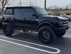 a large black truck parked in a parking lot