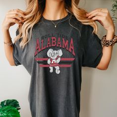 *Also available as a sweater. See below.* Kick it old school with our Retro Alabama T-Shirt! This stylish tee combines a vintage look with your love for Alabama football. Show off your team spirit in a quirky and fun way. Go team! College Football Season T-shirt With Screen Print, College Football Season Screen Print T-shirt, Retro College T-shirt For Football Season, Retro Game Day T-shirt With Screen Print, Retro Team Name T-shirt For Fans, Retro Tops For College Football Season, Vintage Graphic Print Football T-shirt, Vintage Graphic T-shirt For Football Season, Vintage Graphic Print T-shirt For Football Season