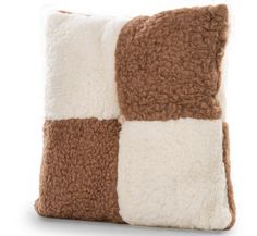 a brown and white pillow sitting on top of a table