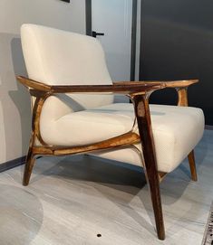 a white chair sitting on top of a hard wood floor