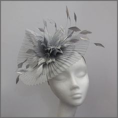 An elegant and sophisticated pleated silver crinoline fascinator. Trimmed with gorgeous feathers and diamantés. A great addition to any special occasion outfit. Made on a headband. Perfect headpiece for ladies day, special occasion or formal event. Designs can be made to order in a range of different colours or styles, see our colour chart: www.jacquivaledesigns.com/colour_chart.html Please contact me if you would like a design in a different colour. We can make a range of ladies hats, fascinato Pleated Crinoline Fascinator, Crinoline Fascinator, Silver Fascinator, Silver Headpiece, Ladies Hats, Silver Head Piece, Occasion Outfit, Wedding Fascinators, Head Wear