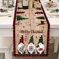 a table with christmas decorations and wine bottles on it