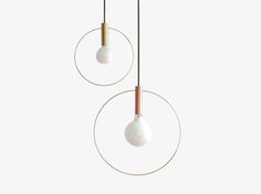 two white and gold lights hanging from the ceiling