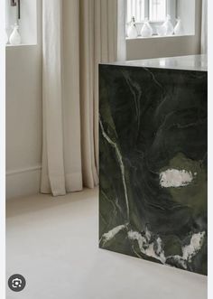 a black and white marble block in front of a window