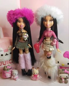 two dolls are standing next to each other