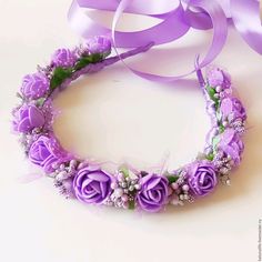 a purple flower crown with flowers and pearls