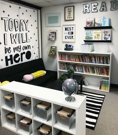 an office cubicle with bookshelves, shelves and pictures on the wall above it