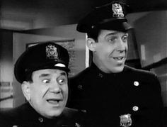 two men in uniform are making funny faces while one man looks surprised at the camera