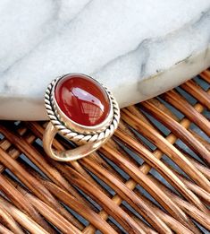 "Carnelian ring,size 8,silver,vintage ring,aqeeq ring,gift,statement ring,jewellery,middle eastern,Persian,big stone, unique Size:8 US Beautiful carnelian ring. Oval shape stone with rope design frame. Solid thick band sets really well on finger. The design of this beautiful ring is inspired by Persian jewellery. ► Giving this as a gift? Don't worry, it comes in beautiful packaging, and ready for gift giving! If you would also like to include a small message, please leave a note during checkout. ► If ordering multiple items, I will automatically package them in the same gift box. If you would like to have them packaged in their own individual gift box, then please leave me a note at checkout in \"note to seller\". -gift wrapping  -great as a gift" Rings Vintage Boho, Aqeeq Ring, Red Gemstone Ring, Silver Gift Wrap, Design Frame, Carnelian Ring, Red Gemstones, Rope Design, Ring Oval