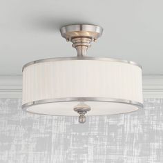 a ceiling light with a white shade on it