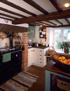 a kitchen with an oven, sink and fruit bowl