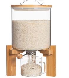 a rice dispenser with a wooden handle and glass container on the top