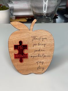 an apple shaped wooden puzzle with the words, that's you for helping someone impersoning any story