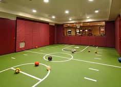 an indoor basketball court with balls on it and the words home and business written below