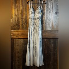 a white dress hanging on a wooden wall