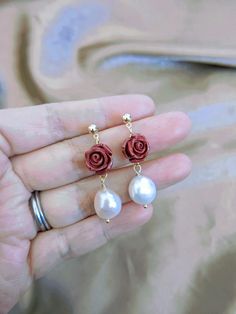 These Rose pearl earrings, Baroque pearl and red rose earrings, Freshwater pearl dangle earrings, Rose earrings, Red rose earrings are so classic and pretty. They are made with cinnabar red rose and big freshwater pearls (approximately 9-11mm). The combination is so beautiful. Cinnabar is a mineral. It has a bright red color that has caused people to use it as a pigment, and carve it into jewelry and ornaments for thousands of years in many parts of the world. In Chinese culture, cinnabar is oft Elegant Rose Red Flower Earrings, Elegant Rose Drop Flower Earrings, Rose Gold Flower Earrings With Roses, Elegant Rose Flower Drop Earrings, Elegant Rose Red Flower Earrings For Wedding, Elegant Rose Details Jewelry For Party, Elegant Rose Red Earrings For Valentine's Day, Elegant Rose Red Jewelry With Rose Design, Elegant Rose Flower Earrings For Gift