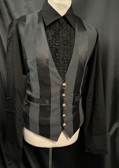 "This is a stunning black heavy suiting fabric waist coat.It is fully lined .It has wide stripes. It has  pockets and adjustable back  . It has rustic buttons. It comes with a black shirt with ruffle detail down the front. this is a high quality garment.  Chest measurement is approx 44\"  Adjustable waist . High quality well made Makes a stunning steampunk gentleman's outfit! Thank you for looking" Gothic Black Vest For Costume Party, Black Elegant Vest For Costume, Elegant Black Vest For Costume Party, Elegant Black Vest For Costume, Gothic Black Vest For Costume, Steampunk Aesthetic Outfit Male, Steampunk Style Black Vest For Costumes, Steampunk Black Vest For Costume Party, Black Steampunk Vest For Costume Party