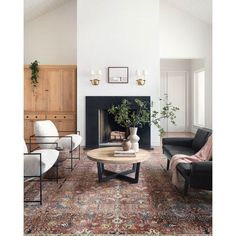 a living room filled with furniture and a fire place