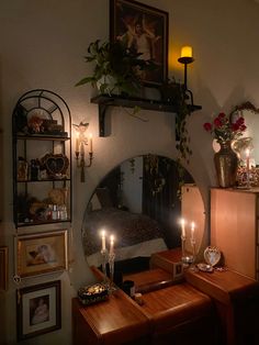 a bedroom with candles and pictures on the wall