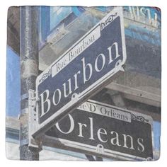 two street signs on the corner of bourbon and orleans