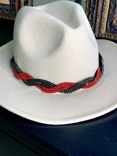 Add a little sparkle to any hat in seconds.  This beautifully hand beaded hat band is fully adjustable to fit any style hat.  The Georgia hat band is an exquisite twisted pattern of black and red crystals that add elegance to your cowboy hat or sun hat!  Hat NOT included. What makes our Hat Bands different? *Adjustable- all of our elastics are removable and adjustable for the perfect fit. *Try our hat bands on your boots too. * Can also be worn as a headband All of our pieces are hand beaded with quality in mind.  Each hat band comes with the removable and adjustable elastic for maximum comfort and usability. People who loved this hat band also loved our Brittany hat band found here: https://www.etsy.com/listing/524577308 Adjustable Rhinestone Hat Bands For Party, Adjustable Fedora With Rhinestones, Adjustable Rhinestone Hat Bands For Festivals, Adjustable Brimmed Hat With Rhinestones, Adjustable Curved Brim Felt Hat For Parties, Adjustable Short Brim Fedora For Parties, Festival Fedora Hats With Rhinestones, Adjustable Brimmed Fedora For Parties, Adjustable Beaded White Hat