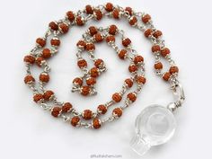 "This Mala is made of small sized 5 Mukhi Rudraksha beads of size 5 mm with Crystal Sphatik Shivling pendant in silver caps and wire. Crystal Shivling : The Crystal Shivling is a symbol of radiant white light energy. It is believed, Lord Shiva and Goddess Parvati (Shakti) live in this stone. Crystal Shivling harmonize the aura around us and remove the negative energy, therefore when we place this crystal Shivling , in our home or office, the place is purified by the power of crystal and the bles Spiritual Pendant Crystal Necklace With Polished Beads, Spiritual Silver Crystal Necklace With Polished Beads, Spiritual Necklaces With Silver Beads For Puja, Spiritual Silver Beaded Necklaces For Puja, Handmade Silver Mala Spiritual Style, Handmade Silver Mala For Spiritual Practices, Spiritual Silver Crystal Necklace With 8mm Beads, Silver Hand-strung Mala As A Gift, Silver Mala With 108 Beads As Gift