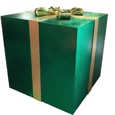 a large green gift box with gold ribbon and bow on the top, sitting in front of a white background