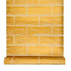 a yellow brick wallpaper with gold foil on the edges and bottom part of it