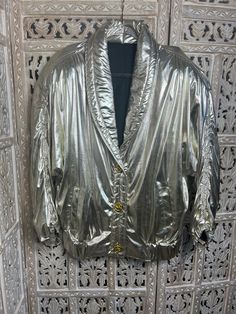 This stylish ladies' vintage casino jacket adds a touch of class to any outfit. It's made from a shiny light gold fabric and features 3 intricately detailed gold buttons. The perfect way to add some dazzle dazzle for a night out or special occasions. Size L/XL Glamorous Metallic Formal Outerwear, Gold Blazer With Gold Buttons For Spring, Gold Long Sleeve Outerwear With Button Closure, Glamorous Gold Outerwear For Formal Occasions, Glamorous Gold Formal Outerwear, Gold Outerwear With Button Closure For Fall, Glamorous Gold Long Sleeve Blazer, Gold Party Blazer With Gold Buttons, Gold Winter Blazer With Buttons