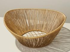 a woven basket sitting on top of a white table