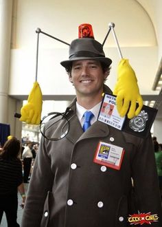 a man dressed as a doctor who is wearing gloves and holding two bananas on his head