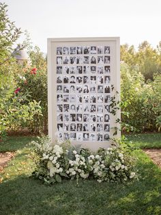 a garden with white flowers and pictures on the wall in it's centerpiece