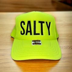 Salty embroidered on your favorite color Otto Foam High-Profile Trucker Hat. How to Order: 1. Choose the color hat  2. Pick the color of thread   Message us with any questions Hat Description:  The Traditional Look 5-panel cap Seamless Foam Front Panel with Lining Matching Color Braid Visor Matching Fabric Undervisor, Adjustable Snapback SHAPE: High-Profile FABRIC:  100% Polyester Front,  Mesh Back VISOR: Pre-curved FIT & SIZE: OSFM - Adult (6 1/2 - 7 5/8) Youth Size (6 - 7 1/8) STRUCTURED Adjus Trendy Sun Hat With Letter Print For Beach, Trendy Beach Sun Hat With Letter Print, Trendy Letter Print Sun Hat For The Beach, Green Trucker Hat For Beach And Summer, Novelty Summer Hats For Outdoor, Green Fun Style Trucker Hat For Vacation, Outdoor Summer Snapback Hat With Letter Print, Casual Beach Trucker Hat With Letter Print, Summer Hats With Letter Print For Beach