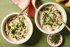 two white bowls filled with food on top of a green table