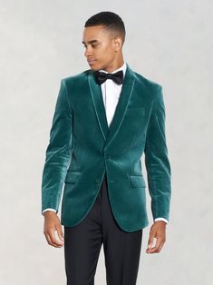 a man in a green velvet jacket and bow tie