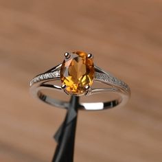 It is a natural citrine ring. The main stone is 7mm*9mm oval cut, weight about 1.77 carats.The basic metal is sterling silver and plated with rhodium.To change the metal to a solid gold (white/rose) or platinum is also available, please ask for a quotation if you want.You can also go to my shop Home for more elegant rings: https://www.etsy.com/shop/godjewelry?ref=hdr_shop_menuMore rings:https://www.etsy.com/shop/godjewelry?ref=l2-shop-header-avatarCustomization is always welcome and please feel Yellow Citrine Ring, Citrine Ring Engagement, November Birthstone Ring, Oval Cut Ring, Yellow Gemstones, Yellow Citrine, Citrine Ring, Citrine Crystal, Natural Citrine