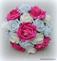 a bridal bouquet with pink, white and blue flowers