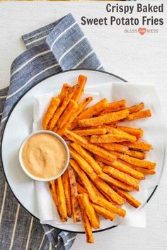 crispy baked sweet potato fries on a plate with dipping sauce